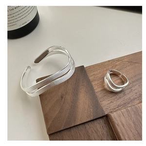Detailed view of S925 sterling silver multilayer wave texture ring and open bangle set