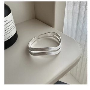 Detailed macro view of S925 sterling silver multi-layer wavy textured open cuff bracelet
