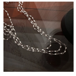 Macro shot of S925 sterling silver wavy twisted chain necklace with sparkling textures