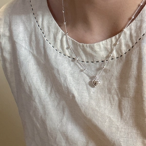 S925 sterling silver heart pendant necklace with bead chain worn on a female model