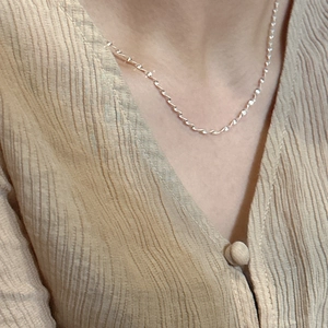 Minimalist S925 sterling silver shimmering water wave chain worn on model's neckline