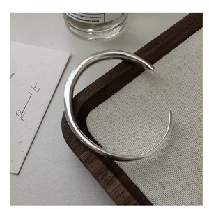 Close-up of S925 sterling silver stamp on minimalist matte finish open cuff bracelet