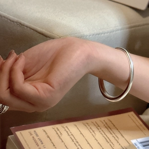 Minimalist S925 sterling silver bangle with polished mirror finish and stacked rings