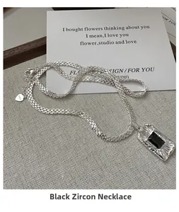 Detail of S925 sterling silver woven chain featuring a rectangle black zircon pendant