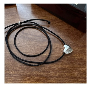 Detail of S925 sterling silver heart pendant on adjustable black braided cord necklace
