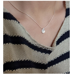 Minimalist S925 sterling silver necklace with a small white agate pendant on a model
