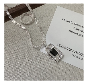 Detail of S925 silver woven chain necklace featuring a rectangular black zircon pendant