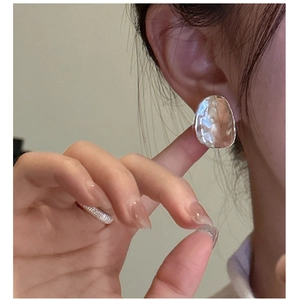Close-up of S925 sterling silver irregular hammered geometric stud earring on model