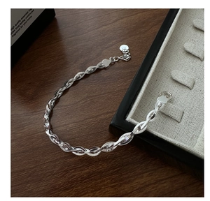 Close-up of S925 sterling silver braided twist bracelet with lobster clasp and tag