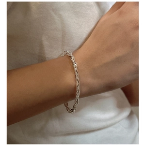 Close-up of S925 sterling silver woven rope chain bracelet on woman's wrist