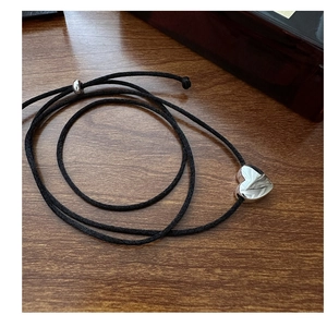 Detail of S925 silver heart pendant on black cord with adjustable slider clasp
