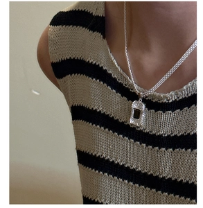 Close-up of S925 silver necklace with a vintage black rectangular zircon pendant on a model