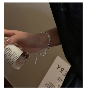Detail of S925 sterling silver beaded bracelet with adjustable chain on model's wrist