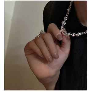Close-up of S925 sterling silver beaded necklace with floral charm and toggle clasp ring