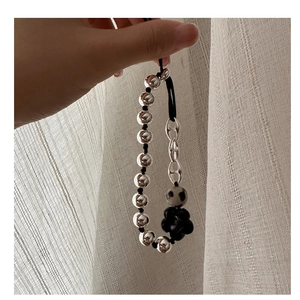Detail of S925 silver beaded bracelet with dalmatian stone and black flower pendant