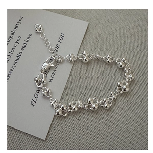 Macro detail of silver bead cluster bracelet with lobster clasp and adjustable chain