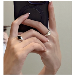 Detail view of S925 silver rings with matte finish and black agate and opal stones