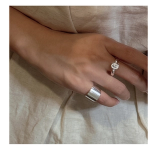 Detailed view of stacked S925 sterling silver rings with polished finish on fingers