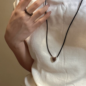 Minimalist S925 silver heart necklace with black cord and beaded ring set on a model