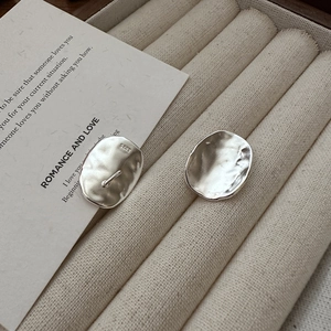 Irregular oval S925 sterling silver stud earrings with handcrafted hammered texture