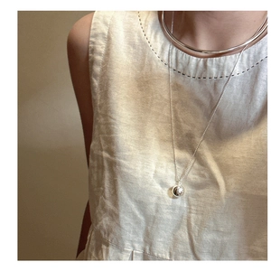 Detail of S925 silver layered necklace with hollow choker and mirror ball pendant