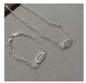 Detail of silver S925 necklace and bracelet set with loveme letter charms and oval links