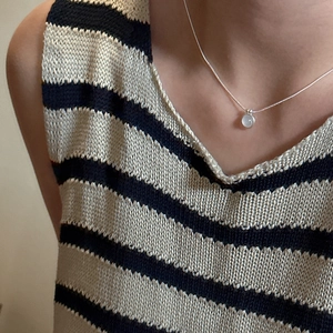 Minimalist S925 sterling silver necklace with a round light blue chalcedony pendant on model