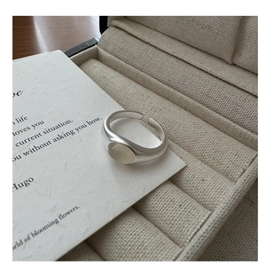 Close-up of S925 sterling silver matte ring with oval moonstone in a jewelry box