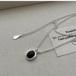 Detail of S925 sterling silver necklace featuring an oval black agate stone pendant