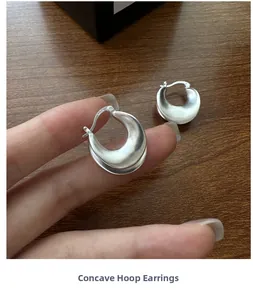 Detail shot of matte S925 sterling silver U-shaped earrings with hallmark engraving