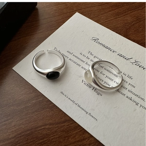 Close-up of S925 sterling silver rings with matte finish and black and white stones