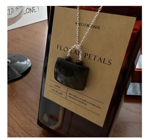 Macro shot of S925 silver necklace with rectangular black obsidian stone pendant