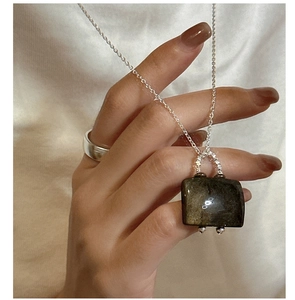 Detail of S925 silver necklace featuring a black rectangular stone pendant on a fine chain