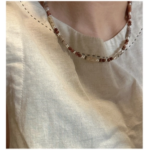 Detail view of handmade S925 silver beaded necklace with brown marble and metallic beads