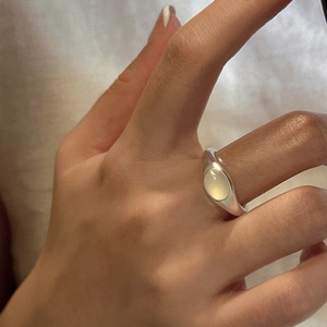 Minimalist S925 sterling silver ring with oval cream gemstone on female hand