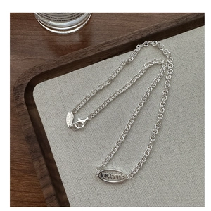 Macro detail of S925 silver chain featuring engraved Love Me and Thanks Nice charms