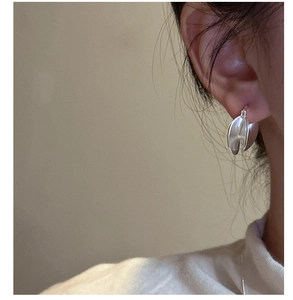 Close-up of minimalist S925 sterling silver double-layer U-shaped earrings on model