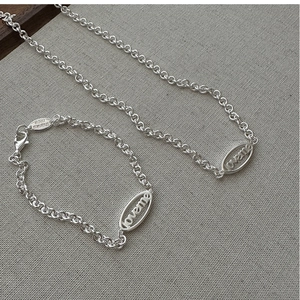 Close-up of S925 sterling silver chunky chain necklace with loveme engraved tags