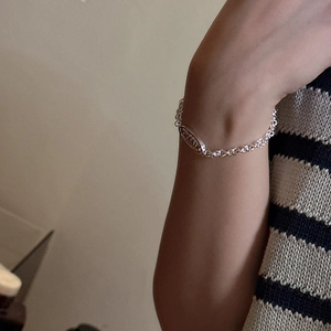 Minimalist S925 sterling silver chain bracelet with engraved oval tag on a female wrist
