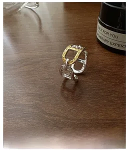 Detail of S925 silver equestrian ring with two-tone gold and silver horsebit link design
