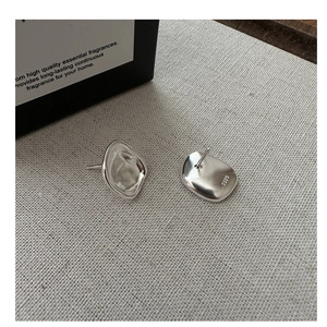 Close-up of S925 sterling silver earring back with pebble texture and hallmark