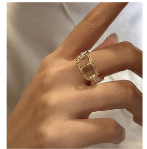 Macro shot of two-tone S925 silver ring featuring gold engraved anchor link detail