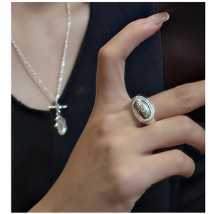 Detail of S925 sterling silver soap ring with SOAP engraving worn on middle finger