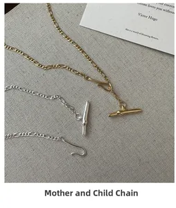 Detail of S925 silver Figaro necklace set with T-bar hook toggle in gold and silver