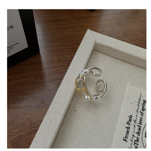 Detailed macro view of S925 silver and gold-tone chain link ring with textured finish