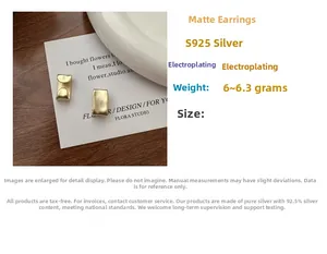 Macro detail of matte gold S925 sterling silver ear clips showing fine brushed texture