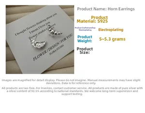 Macro detail of S925 sterling silver croissant earrings with smooth electroplated finish