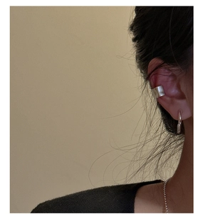 Polished silver textured ear cuff and ball chain necklace on a female model