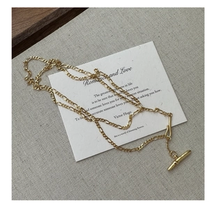 Detail of S925 silver double-layered Figaro sweater chain with vintage T-toggle clasp