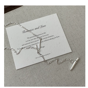 Close-up of S925 sterling silver Figaro chain necklace with a classic toggle clasp design